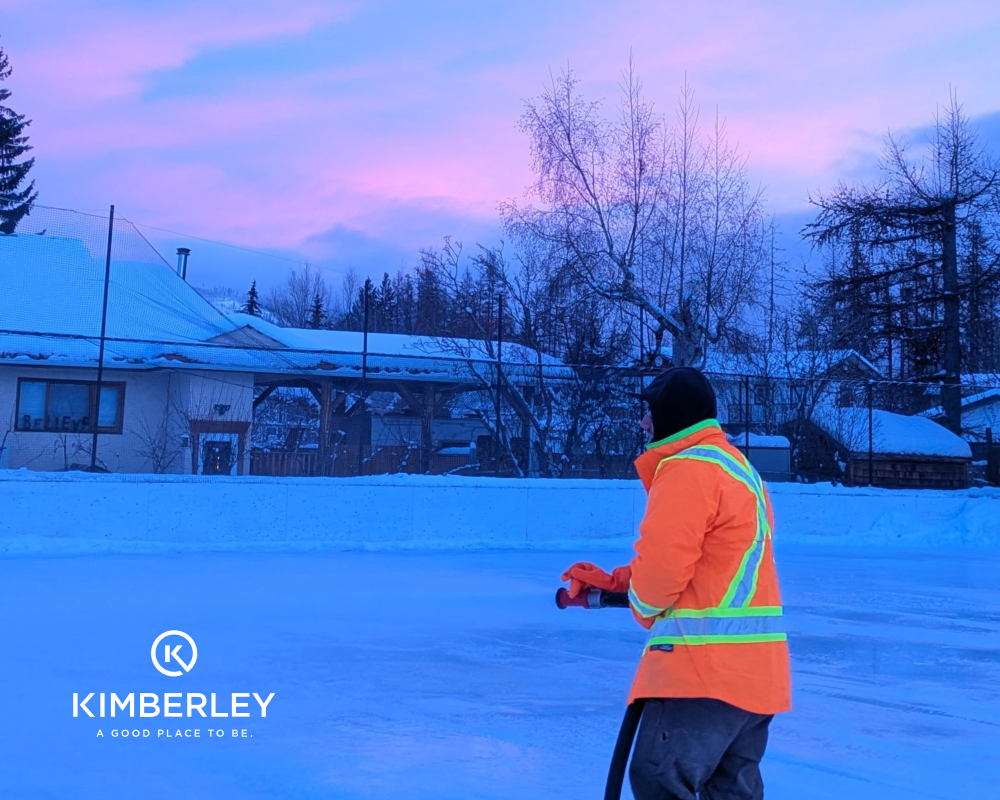 City staff member flooding outdoor ice rink using hose